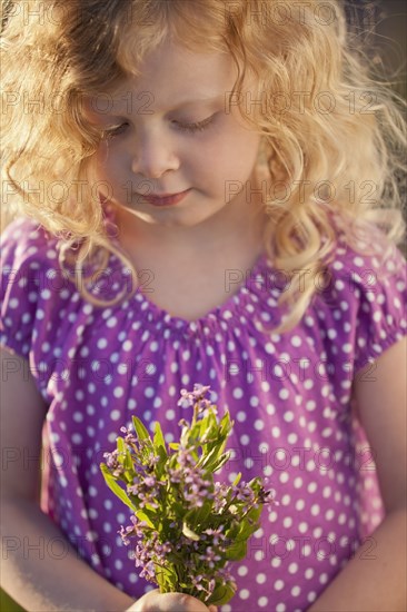 Caucasian girl picking flowers