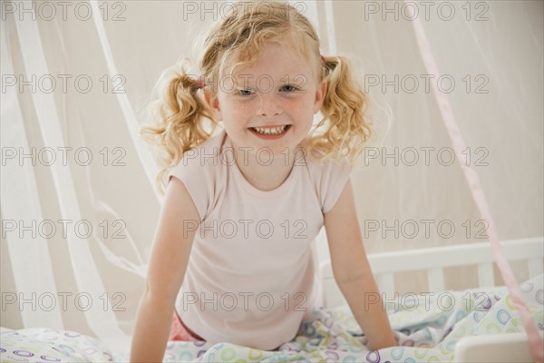 Smiling Caucasian girl in bed