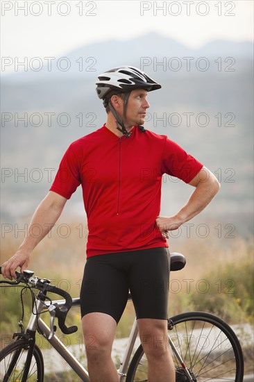 Caucasian man standing near bicycle