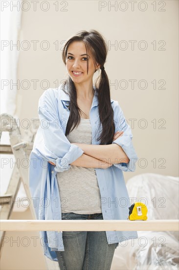 Caucasian woman measuring wood