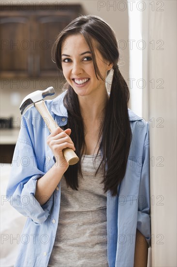 Caucasian woman holding hammer