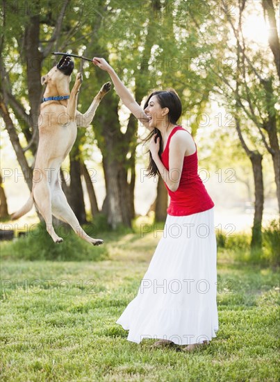 Caucasian woman playing with dog