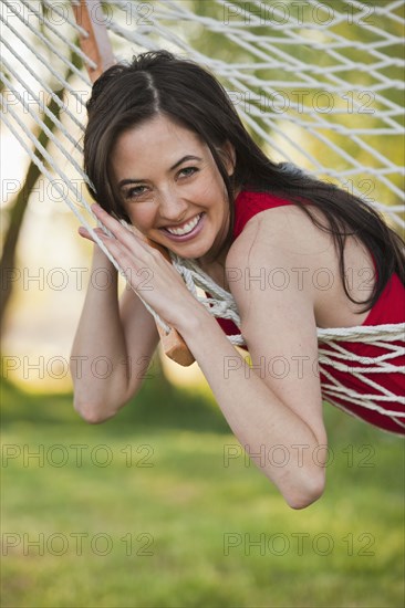 Caucasian woman laying in hammock