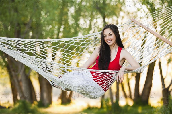 Caucasian woman laying in hammock