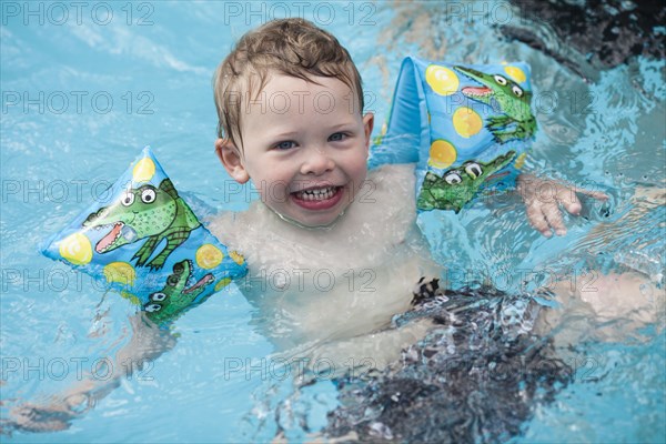 Caucasian boy swimming in swimming pool