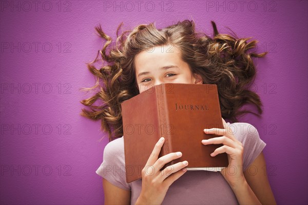 Caucasian teenager holding journal