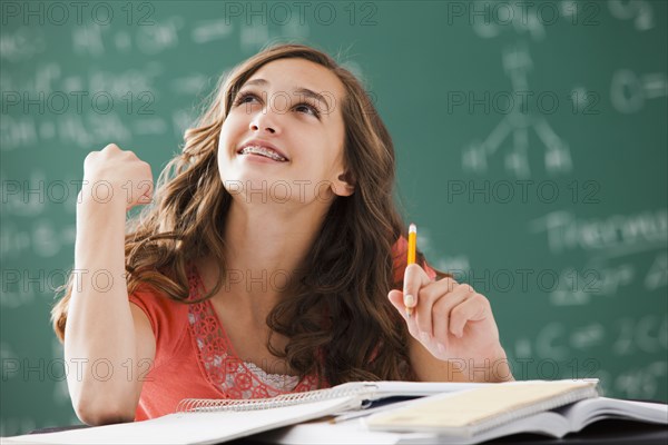 Caucasian teenager daydreaming in classroom