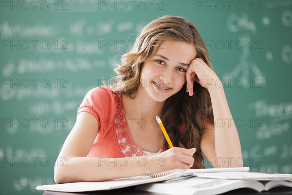 Caucasian teenager studying in classroom