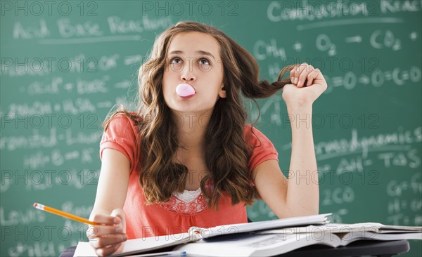 Caucasian teenager daydreaming in classroom