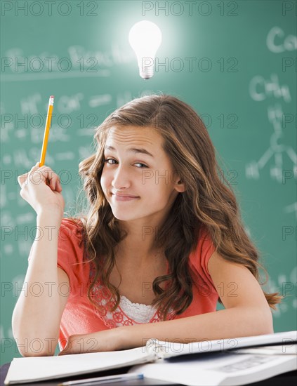 Caucasian student with light bulb over her head