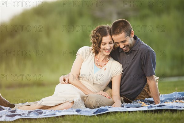 Caucasian couple enjoying picnic