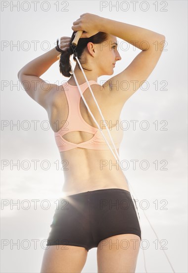 Caucasian woman standing with jump rope