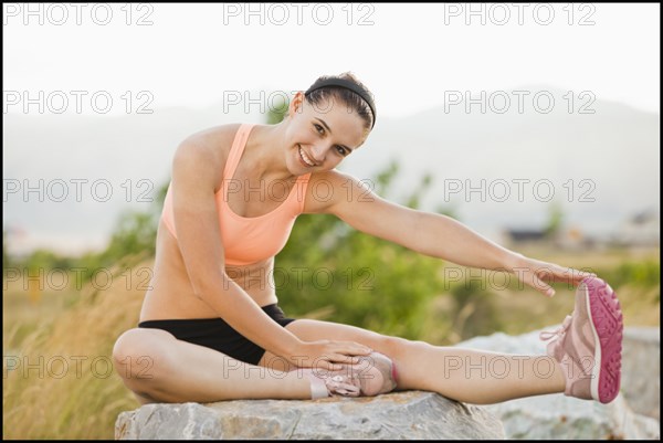 Caucasian woman stretching before workout