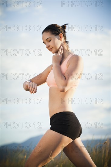 Caucasian woman checking her pulse after exercise