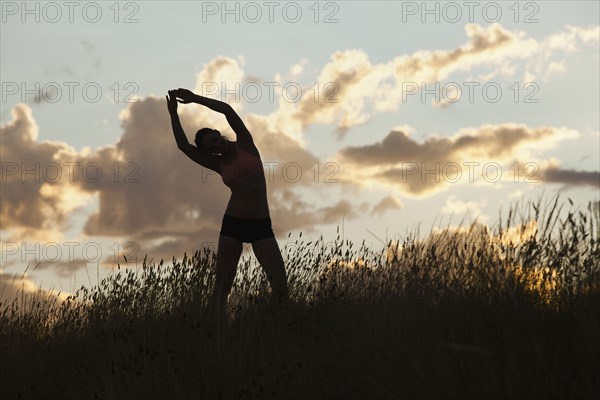 Caucasian woman stretching before exercise