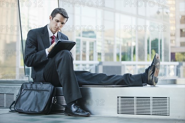 Caucasian businessman using digital tablet