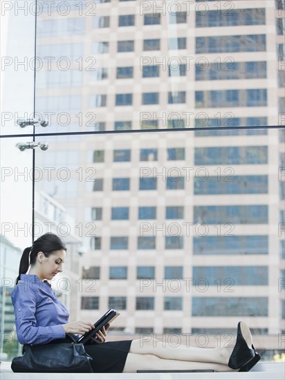 Caucasian businesswoman using digital tablet