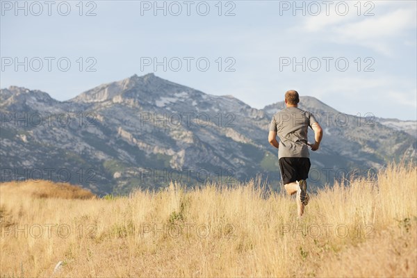 Caucasian man running in remote area