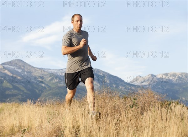 Caucasian man running in remote area