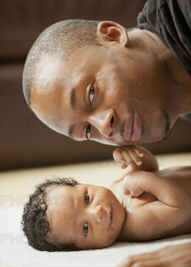 Father bonding with newborn baby