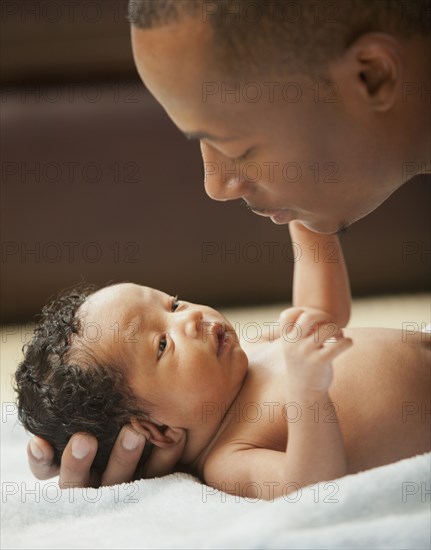 Father bonding with newborn baby