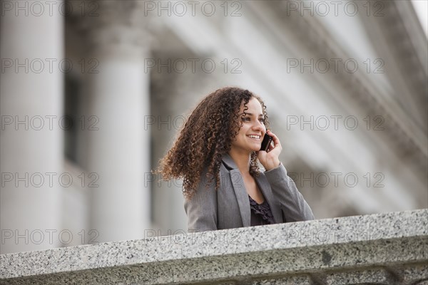 Caucasian businesswoman talking on cell phone outdoors