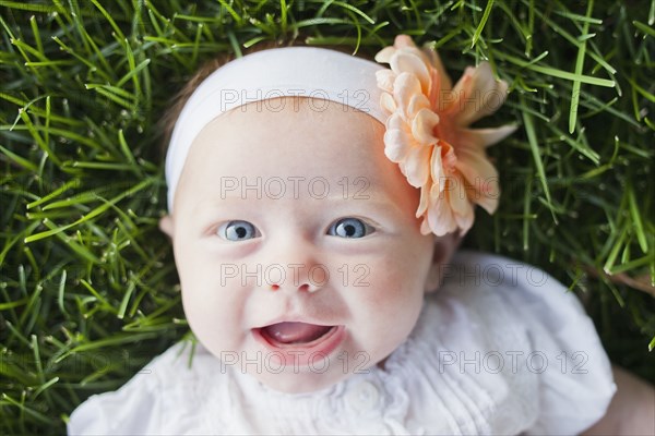 Caucasian baby girl laying in grass