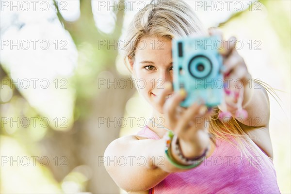 Caucasian woman taking photographs