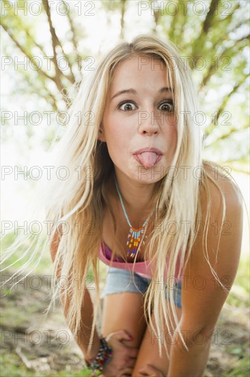 Caucasian woman sticking out tongue