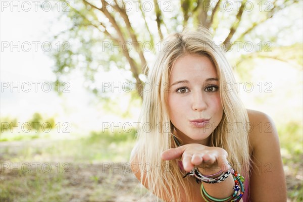 Caucasian woman blowing a kiss