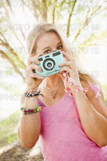 Caucasian woman taking photographs