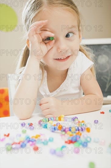 Caucasian girl playing with beads