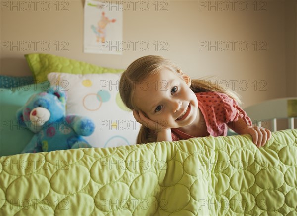 Caucasian girl laying on bed