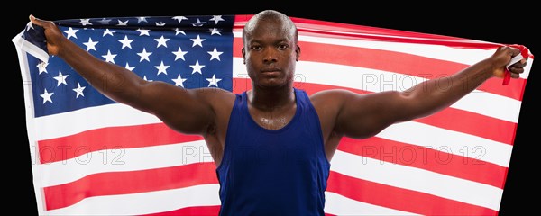 African American athlete holding American flag