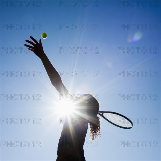 Caucasian woman playing tennis