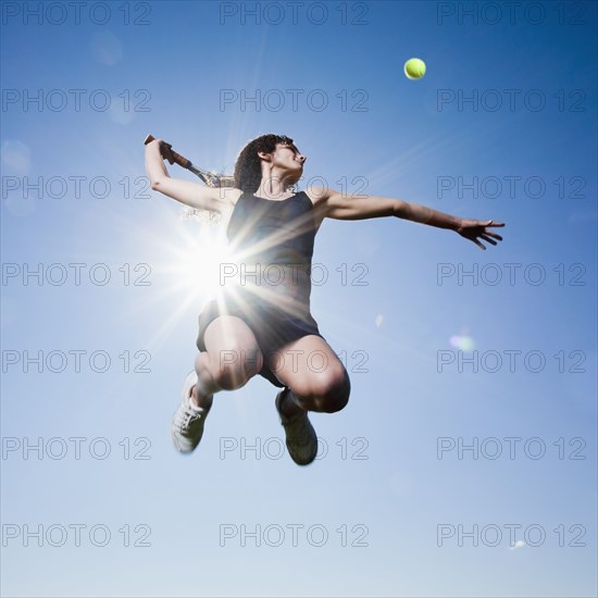 Caucasian woman playing tennis