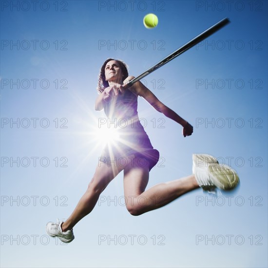 Caucasian woman playing tennis