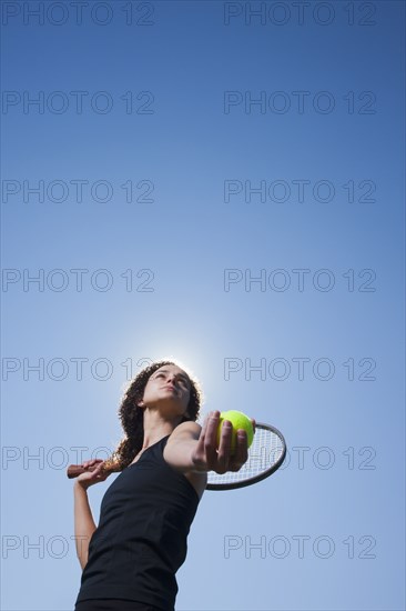 Caucasian woman playing tennis