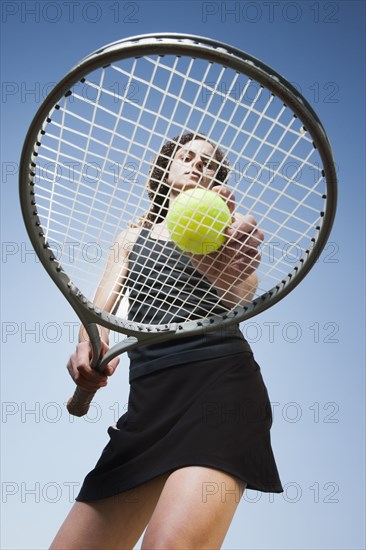 Caucasian woman playing tennis