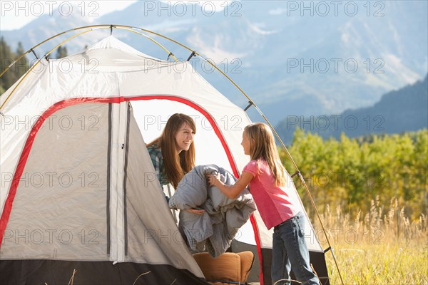 Caucasian mother and daughter camping