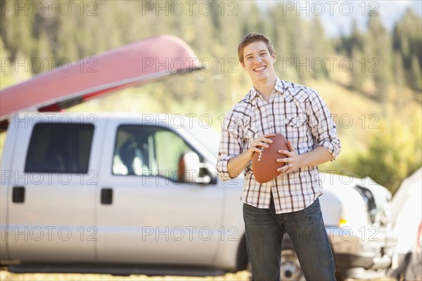 Caucasian man holding football