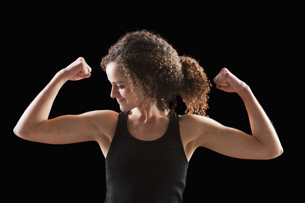 Caucasian woman flexing biceps