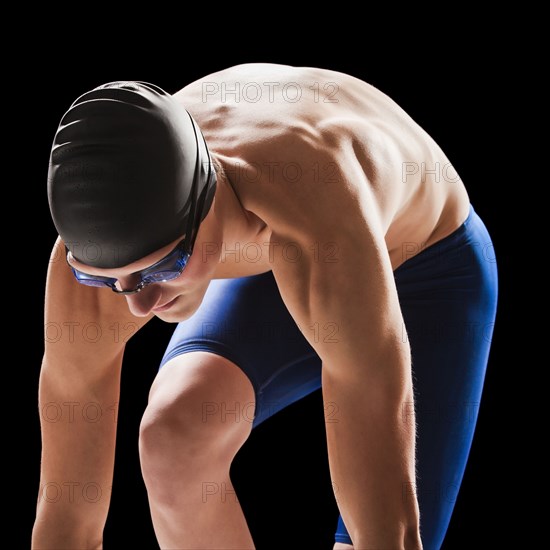 Caucasian teenage boy in swim cap and goggles