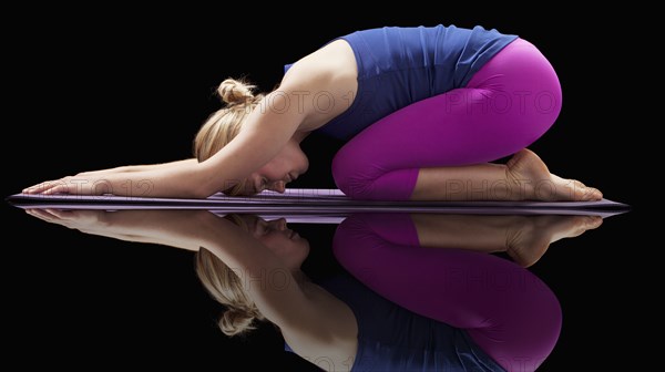 Caucasian woman practicing yoga