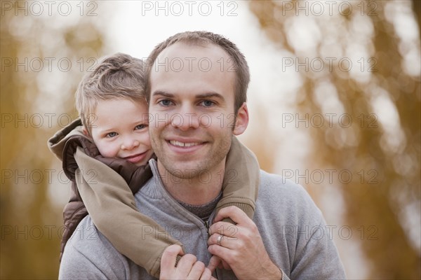 Caucasian father and son hugging