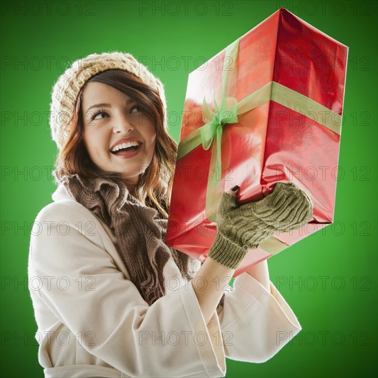 Mixed race woman holding Christmas gift