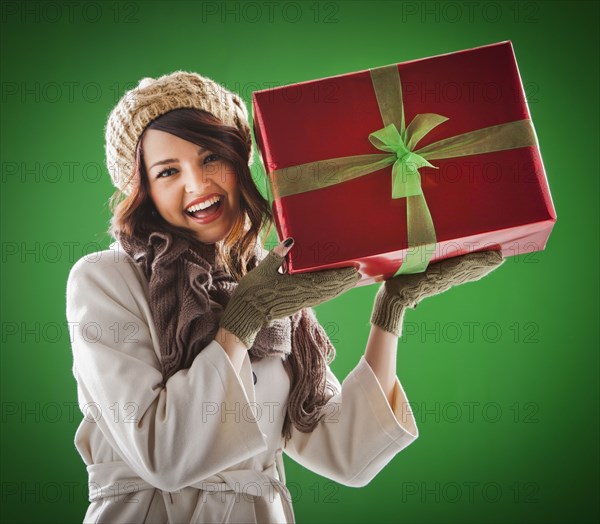 Mixed race woman holding Christmas gift