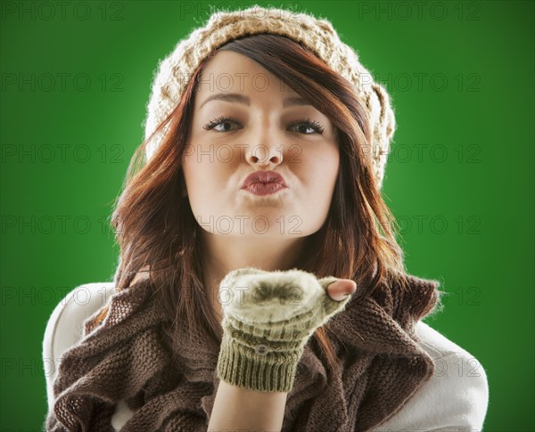 Mixed race woman blowing kisses