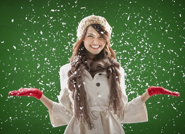 Mixed race woman standing in the snow