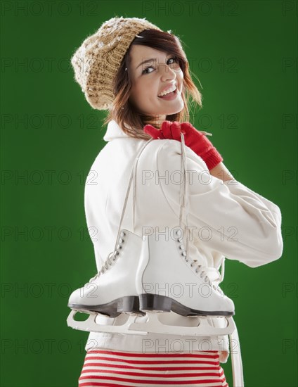 Mixed race woman carrying ice skates
